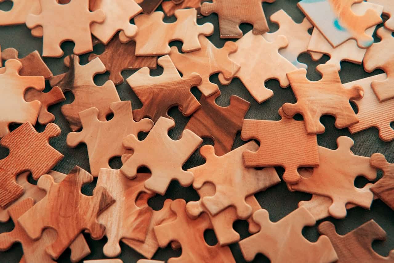 Wooden puzzle pieces representing therapy choices and decision making in CBT vs DBT treatment approaches